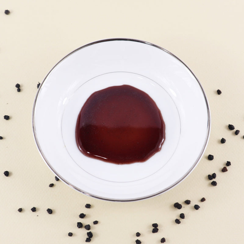 Elderberry infused Honey on a plate to show how premium this special honey is. This is the next best product in your pantry - and the next best part of your health routine.